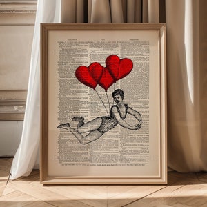 May include: A vintage dictionary page with a black and white illustration of a person holding onto three red heart-shaped balloons. The text on the page is in English.