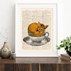 K&ouml;nnte beinhalten: Eine Vintage-W&ouml;rterbuchseite mit einer Illustration eines Fuchses, der in einer Teetasse eingeschlafen ist. Der Fuchs ist orange und die Teetasse ist wei&szlig; mit einem schwarz-wei&szlig;en Blumenmuster.