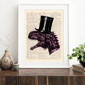 May include: A pink dinosaur wearing a black top hat on a vintage book page background. The dinosaur is facing the right side of the image. The text "Madame Bricolage" is at the bottom of the image.