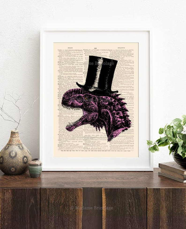 May include: A pink dinosaur wearing a black top hat on a vintage book page background. The dinosaur is facing the right side of the image. The text "Madame Bricolage" is at the bottom of the image.