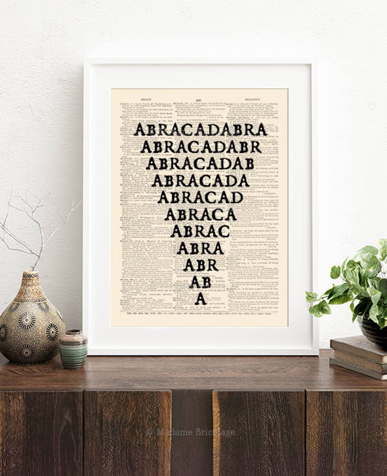 May include: A black and white print of the word "ABRACADABRA" repeated in descending order, printed on a vintage dictionary page with a white frame.