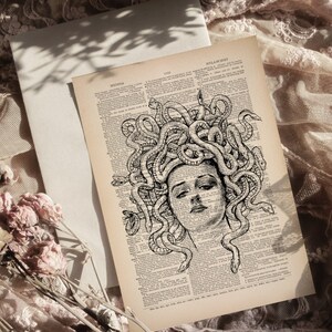 May include: A black and white illustration of Medusa, a mythical Greek figure with snakes for hair, on a vintage book page.