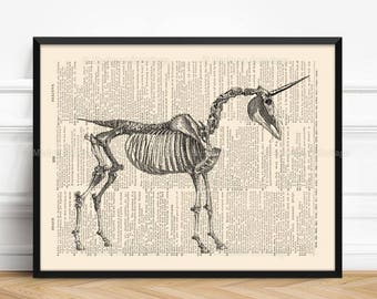 May include: Black and white illustration of a unicorn skeleton on a vintage book page. The skeleton is facing right and has a long horn.