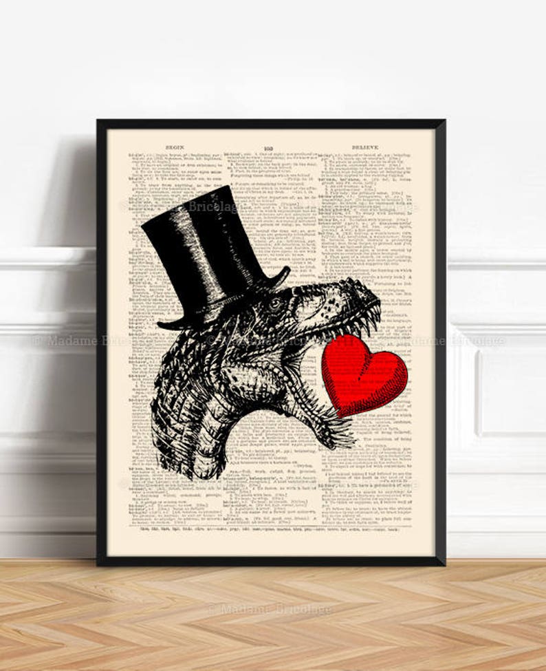 May include: A black and white illustration of a Tyrannosaurus Rex wearing a top hat and holding a red heart. The illustration is printed on a vintage dictionary page.