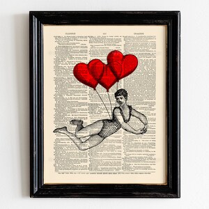 May include: A vintage dictionary page with a black and white illustration of a woman holding onto red heart-shaped balloons. The text on the page reads "ILLUSION" and "IMAGINATION".