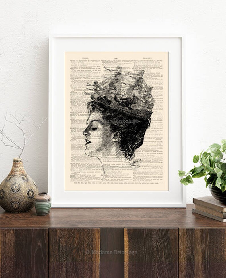 May include: A black and white illustration of a woman's profile with a ship sailing on top of her head. The image is printed on a vintage book page with text.