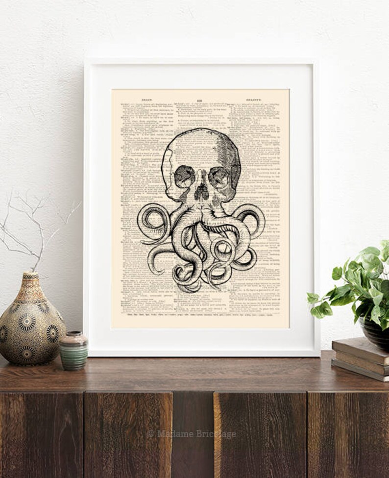 May include: A black and white illustration of a skull with an octopus's tentacles wrapped around it. The image is printed on a vintage dictionary page.