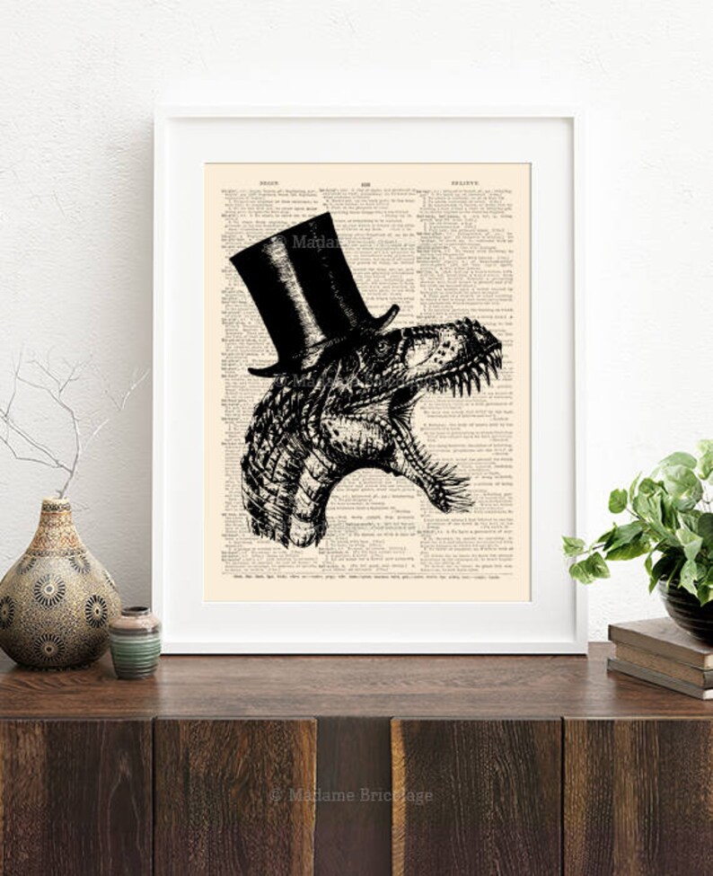 May include: A black and white illustration of a Tyrannosaurus Rex wearing a top hat. The illustration is printed on a vintage book page.