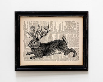 May include: A black and white illustration of a rabbit with a floral crown on its head. The image is printed on a vintage book page.