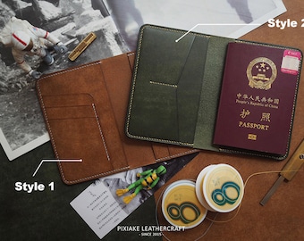 May include: Two styles of leather passport holders. The first is brown with multiple pockets and white stitching. The second is green with a single pocket and yellow stitching. Both are open to show the inside. A passport is visible in the second holder.