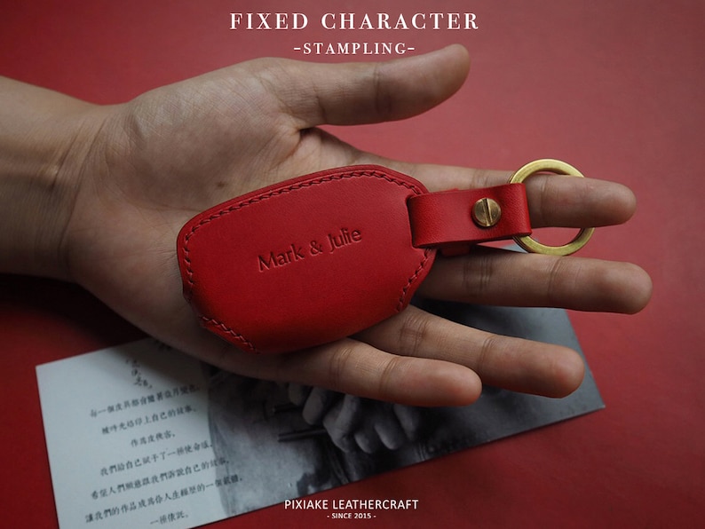 May include: Red leather key chain with a gold ring and the text "Mark & Julie" embossed on the front.
