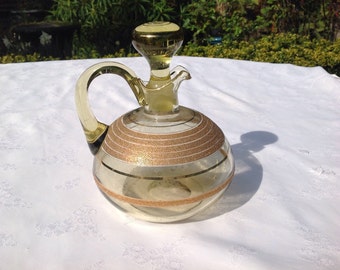 Glass decanter jug with gold metal decoration