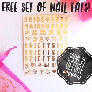 May include: A set of gold nail decals with various bridal-themed designs, including "Bride Tribe", "Maid of Honor", and "Just Drunk in Love". The decals are on a white background and come in a pink organza bag. The image also includes a black and white sticker that says "Spend $25 Before Shipping".