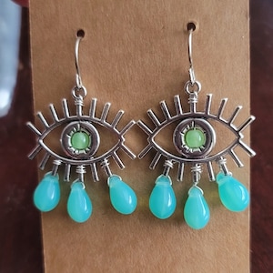 Crying eye earrings with uranium glass pupils and tears
