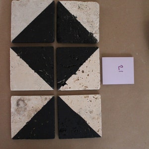 May include: Six square ceramic tiles with a black and white geometric pattern. The tiles are arranged in a 2x3 grid.