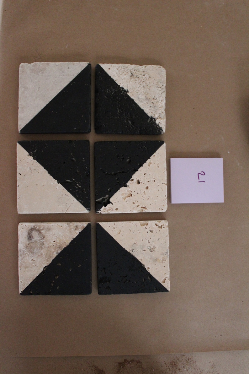 May include: Six square ceramic tiles with a black and white geometric pattern. The tiles are arranged in a 2x3 grid.