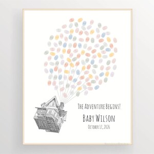 Puede incluir: Impresi&oacute;n enmarcada con una ilustraci&oacute;n de una casa, con globos hechos de huellas dactilares de colores. El texto dice "The Adventure Begins!", con el nombre "Baby Wilson" y la fecha "17 de octubre de 2026".