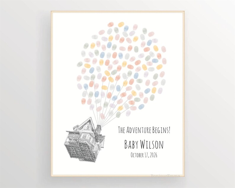 Puede incluir: Impresi&oacute;n enmarcada con una ilustraci&oacute;n de una casa, con globos hechos de huellas dactilares de colores. El texto dice "The Adventure Begins!", con el nombre "Baby Wilson" y la fecha "17 de octubre de 2026".