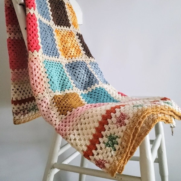 Small hand-crocheted Afghan blanket or plaid, multi-colored "Granny square" type.