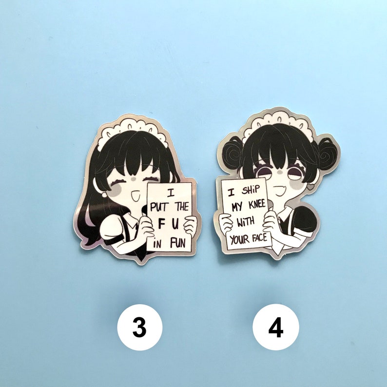 May include: Two holographic stickers featuring a cartoon maid character holding a sign. The first sticker says "I put the FU in fun." The second sticker says "I ship my knee with your face."