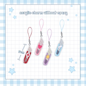 May include: Four acrylic charms shaped like utility knives, each with a different design and color scheme. The charms are attached to colored lanyards. The text "acrylic charm without epoxy" is at the top. The measurement of 5cm is shown.