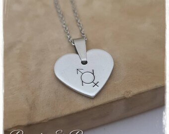May include: A silver heart-shaped pendant necklace with a silver chain. The pendant has a design of the male and female gender symbols.