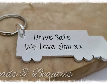 May include: Silver truck-shaped keychain with the text "Drive Safe We Love You xx" engraved on it.