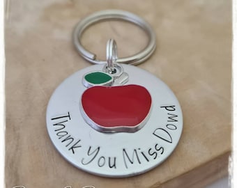 May include: Silver keychain with a red apple charm and the text "Thank You Miss Dowd".