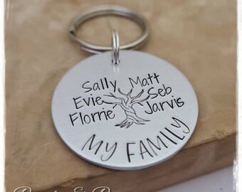 May include: Silver keychain with a tree design and the words "My Family" engraved on it. The names Sally, Evie, Florrie, Matt, Seb, and Jarvis are also engraved around the tree.