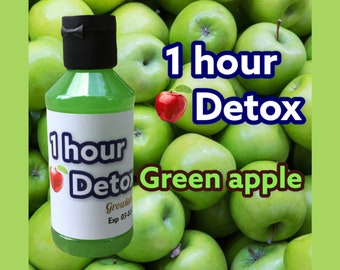 May include: A green bottle with a black cap, filled with a green liquid, is set against a backdrop of green apples. The label reads "1 hour Detox" with a red apple graphic and "Green apple" text.