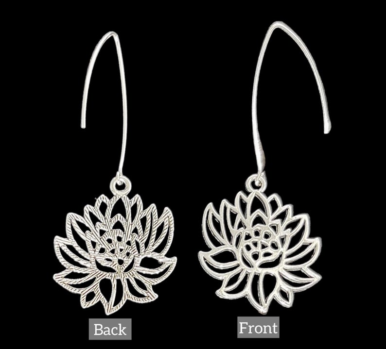 May include: A pair of silver dangle earrings with a delicate lotus flower design. The earrings are shown from the front and back.