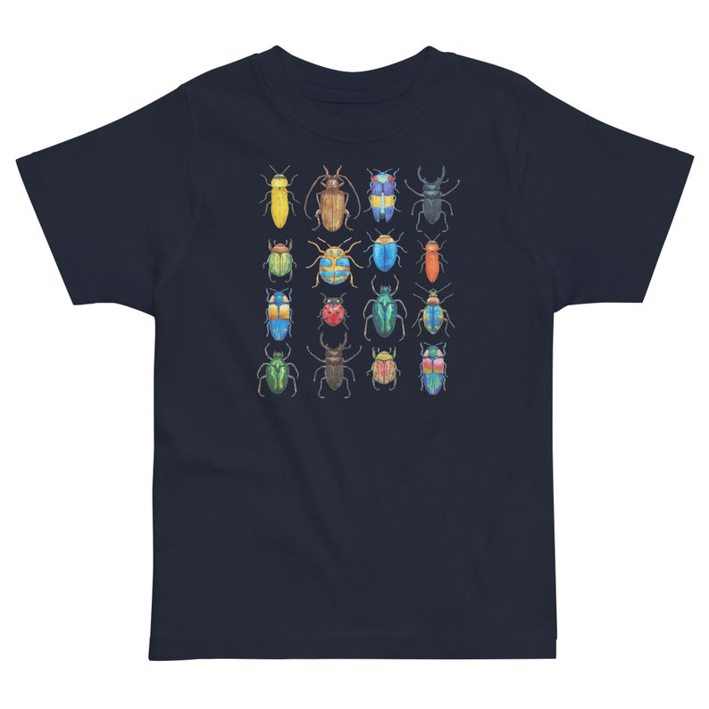 May include: A navy blue t-shirt featuring a colourful pattern of various beetles. The beetles are arranged in a grid pattern and are all different colours and sizes.
