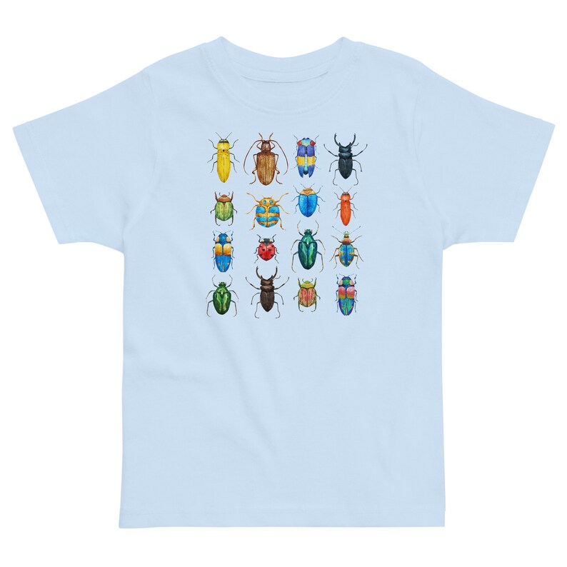 May include: A light blue t-shirt featuring a colourful pattern of 16 different beetles. The beetles are all different colours and have different patterns on their wings.