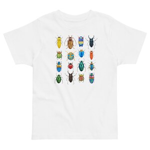 May include: White t-shirt featuring a colourful pattern of 16 different beetles. The beetles are all different colours and have different patterns on their wings.
