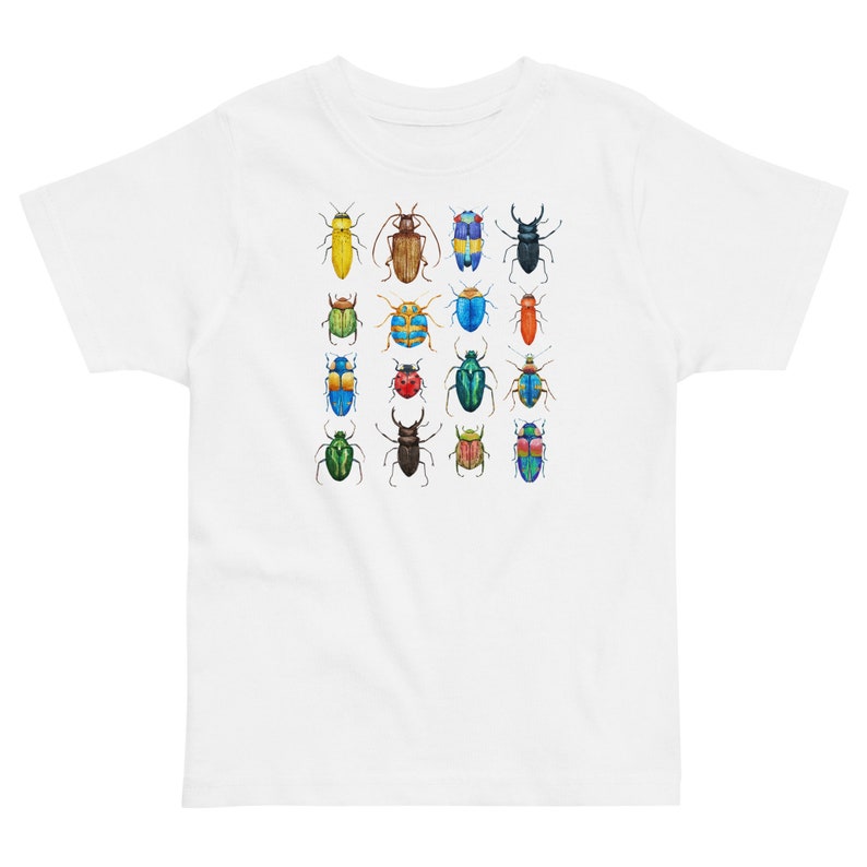 May include: White t-shirt featuring a colourful pattern of 16 different beetles. The beetles are all different colours and have different patterns on their wings.