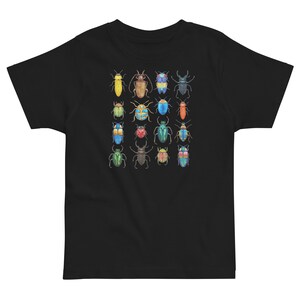 May include: Black t-shirt featuring a colourful pattern of 18 different beetles. The beetles are all different colours and have different patterns on their wings.