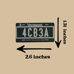 May include: A rectangular Vermont license plate replica featuring the text 4CB3A, Vermont, and Green Mountain State. The plate measures 2.6 inches in width and 1.31 inches in height as indicated by the black arrows and text labels on the image.