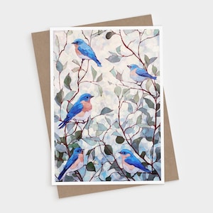 May include: A rectangular greeting card featuring an illustration of four bluebirds perched on thin, dark brown branches. The birds have bright blue feathers on their heads and wings with light peach-colored chests. The background shows soft green leaves.