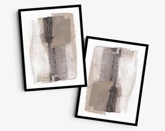 May include: Two framed wall art prints featuring abstract compositions of layered brushstrokes in shades of beige, taupe, gray, and dark charcoal. Each rectangular print is encased in a thin black frame, showcasing textured paint applications on a white background.