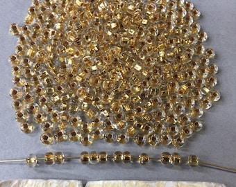 Glass Beads. NOS. 4mm. 24k Gold Lined. Sold by lots of 100 pieces.