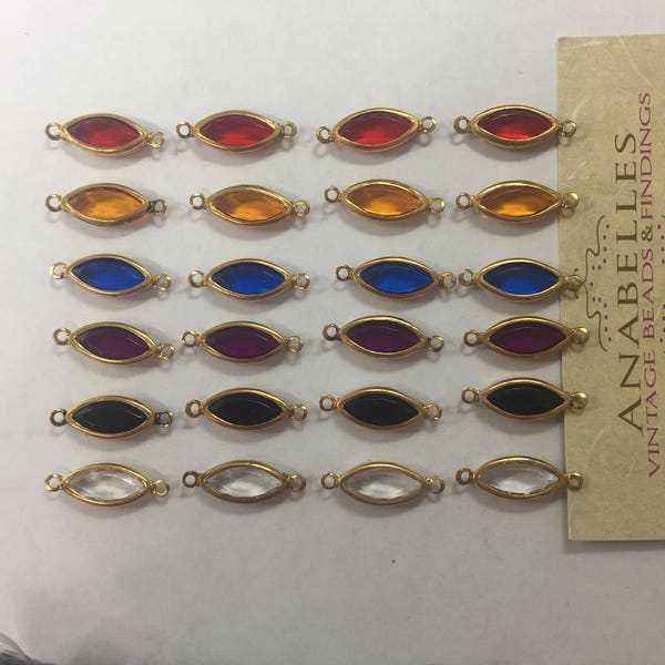 Vintage channel cut beads NOS. 15x7mm  navettes, on gold tone bezel settings. Sold by lots of 36 pieces.