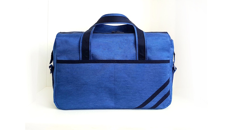 May include: A blue duffel bag with black straps and a black stripe design. The bag has a zipper closure and a shoulder strap.