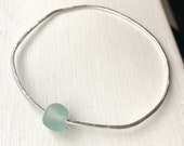 Recycled glass hammered bangle. Blue green glass bead freeform bangle