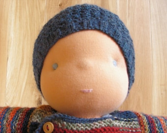 May include: A handmade doll with a blue knitted hat and a striped sweater. The doll has a light brown complexion and blue eyes.