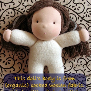 May include: A handmade doll with brown yarn hair and a white felt body. The doll is lying on a patterned fabric background. The text on the image reads: "This doll's body is from (organic) cooked woolen fabric. This is still soft, but a little sturdier than jersey cotton."