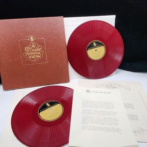 May include: A vintage vinyl record album set, featuring two red vinyl records and a brown album cover. The album is titled "The 100 Greatest Recordings of All Time" with gold lettering. Includes informational inserts.