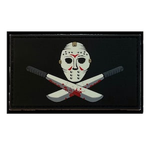 May include: Black and white patch with a hockey mask and two crossed machetes with red blood splatters. The mask has a white background with black holes and red lines.