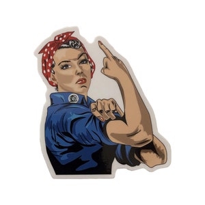 May include: A red, white, and blue polka dot bandana is worn by a woman with dark hair. She is flexing her bicep and pointing her index finger to the right. The woman is wearing a blue shirt with a circular emblem on the left side of her chest.