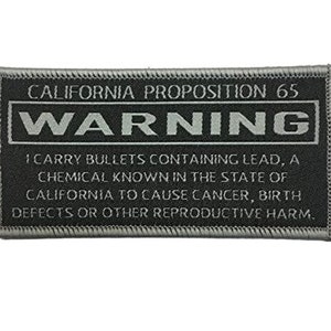 May include: A black and white warning label with the text "CALIFORNIA PROPOSITION 65 WARNING I CARRY BULLETS CONTAINING LEAD, A CHEMICAL KNOWN IN THE STATE OF CALIFORNIA TO CAUSE CANCER, BIRTH DEFECTS OR OTHER REPRODUCTIVE HARM."