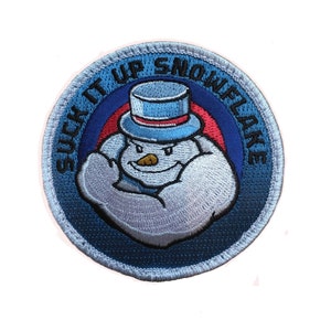 May include: A blue and white embroidered patch with a snowman wearing a top hat and flexing its bicep. The text "SUCK IT UP SNOWFLAKE" is written around the snowman.